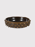 Decorative earth brown mahogany bowl with spike-like protrusions on a light gray background
