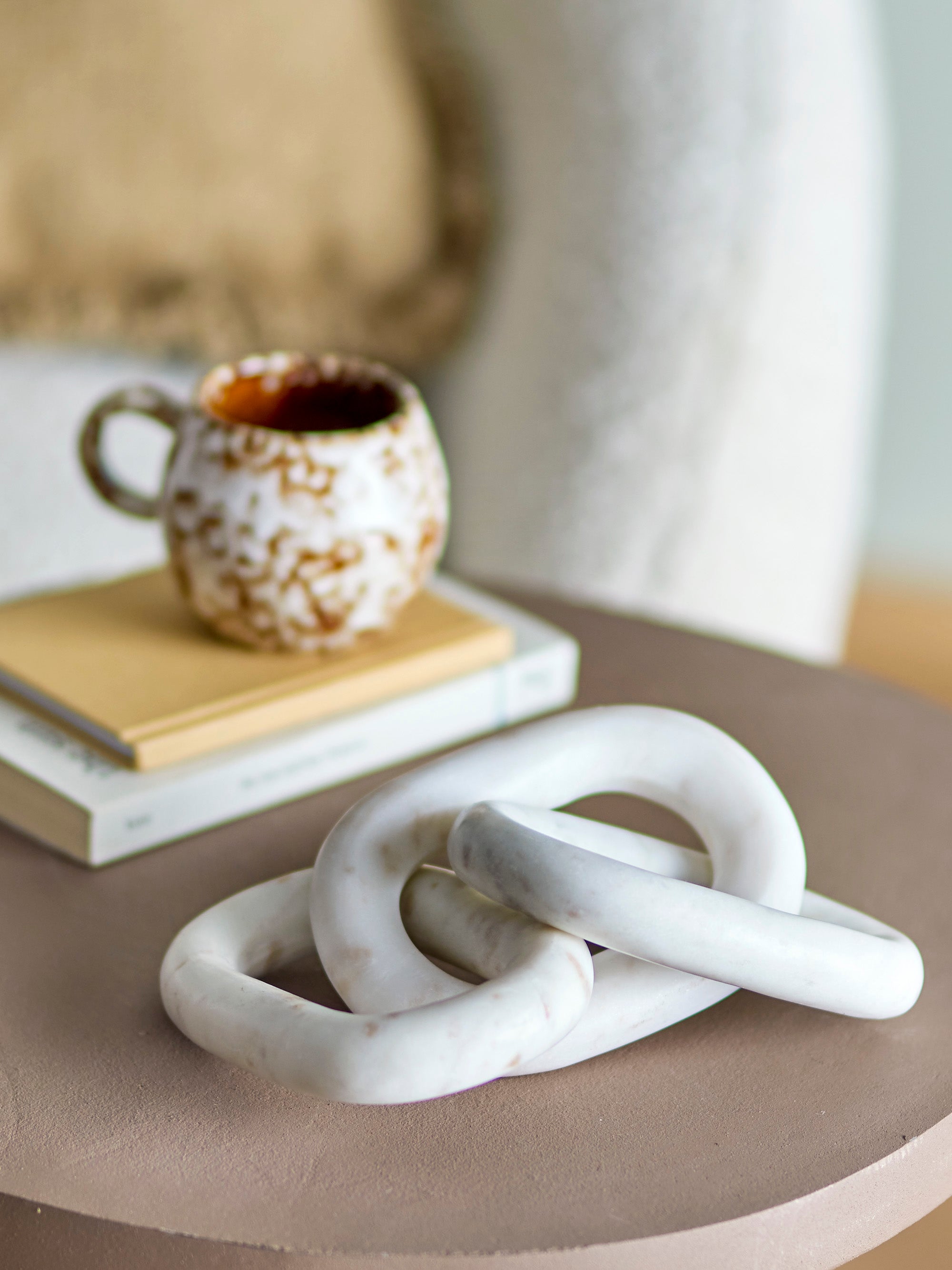 marble rounded chain ornament styled on side table