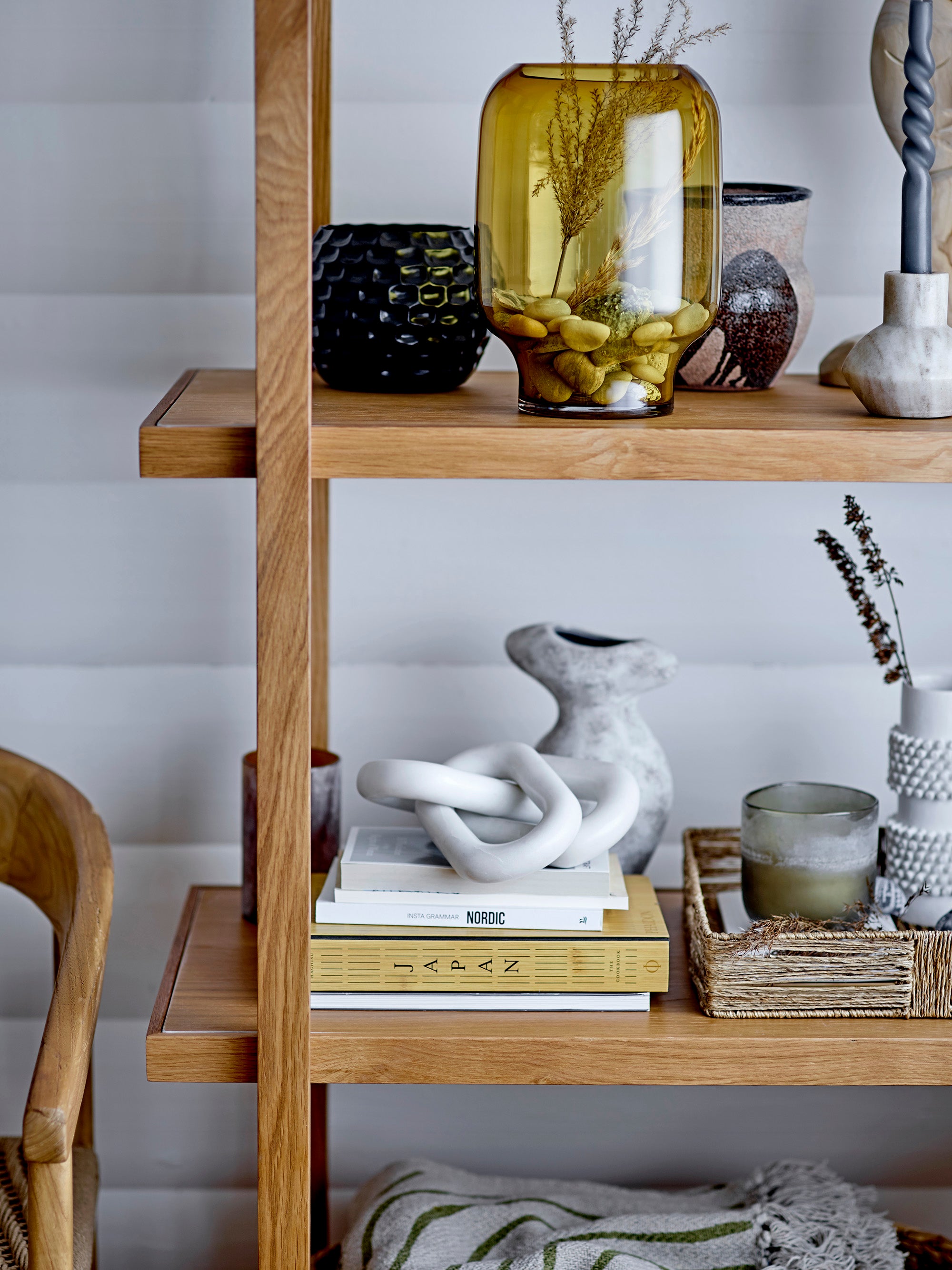 shelf styling with vases of various sizes in glass and ceramic with marble chain link and coffee table books