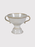 White ceramic urn vase with handles on a light gray background
