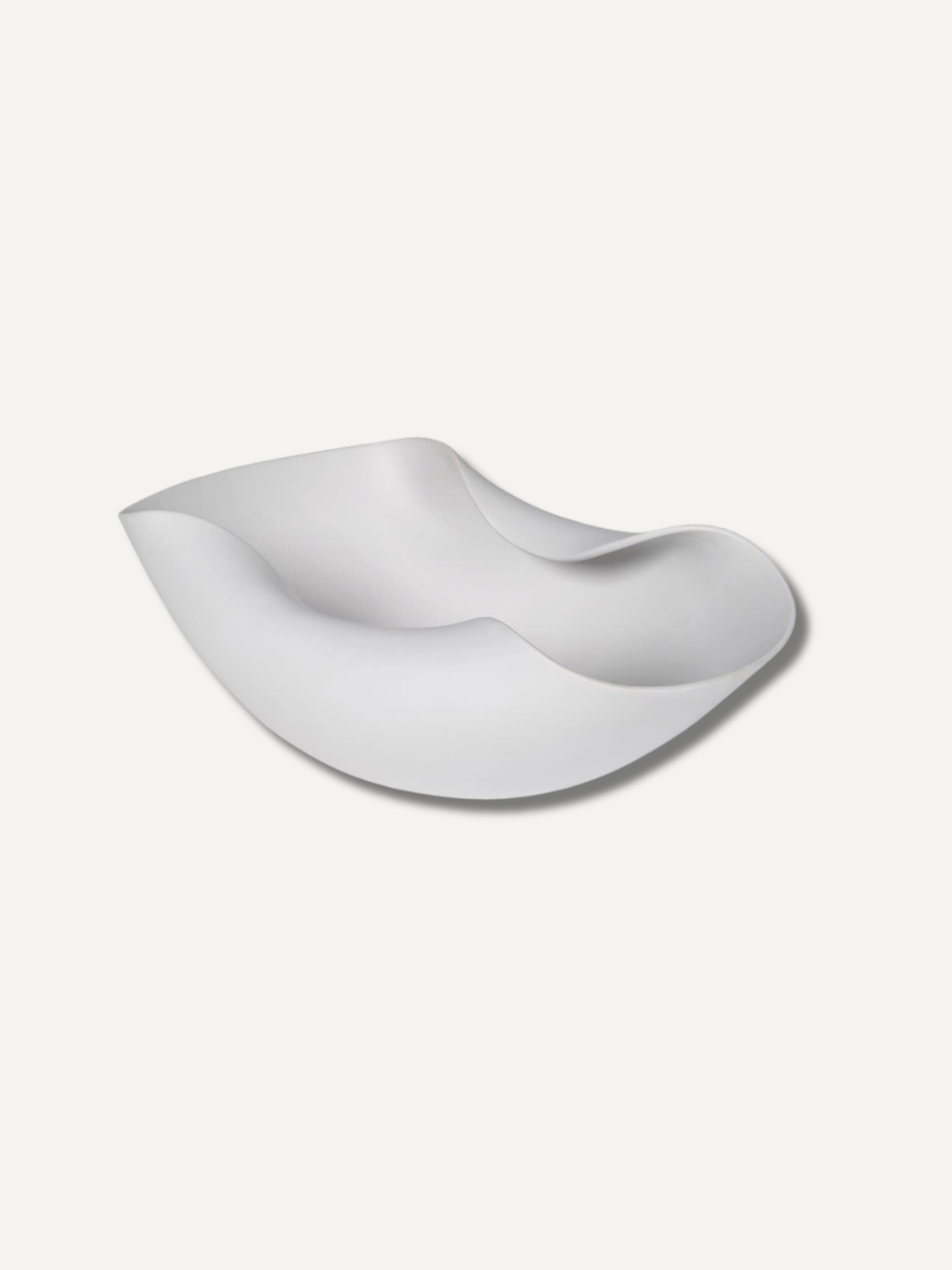 White ceramic bowl with wavy design on a white background for home decor