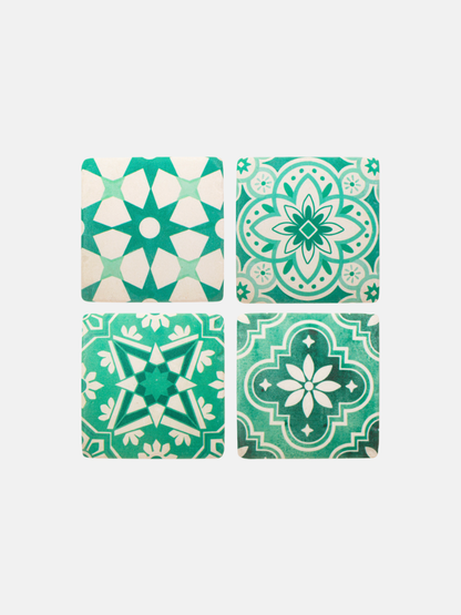 Four green and white patterned tiles on a white background
