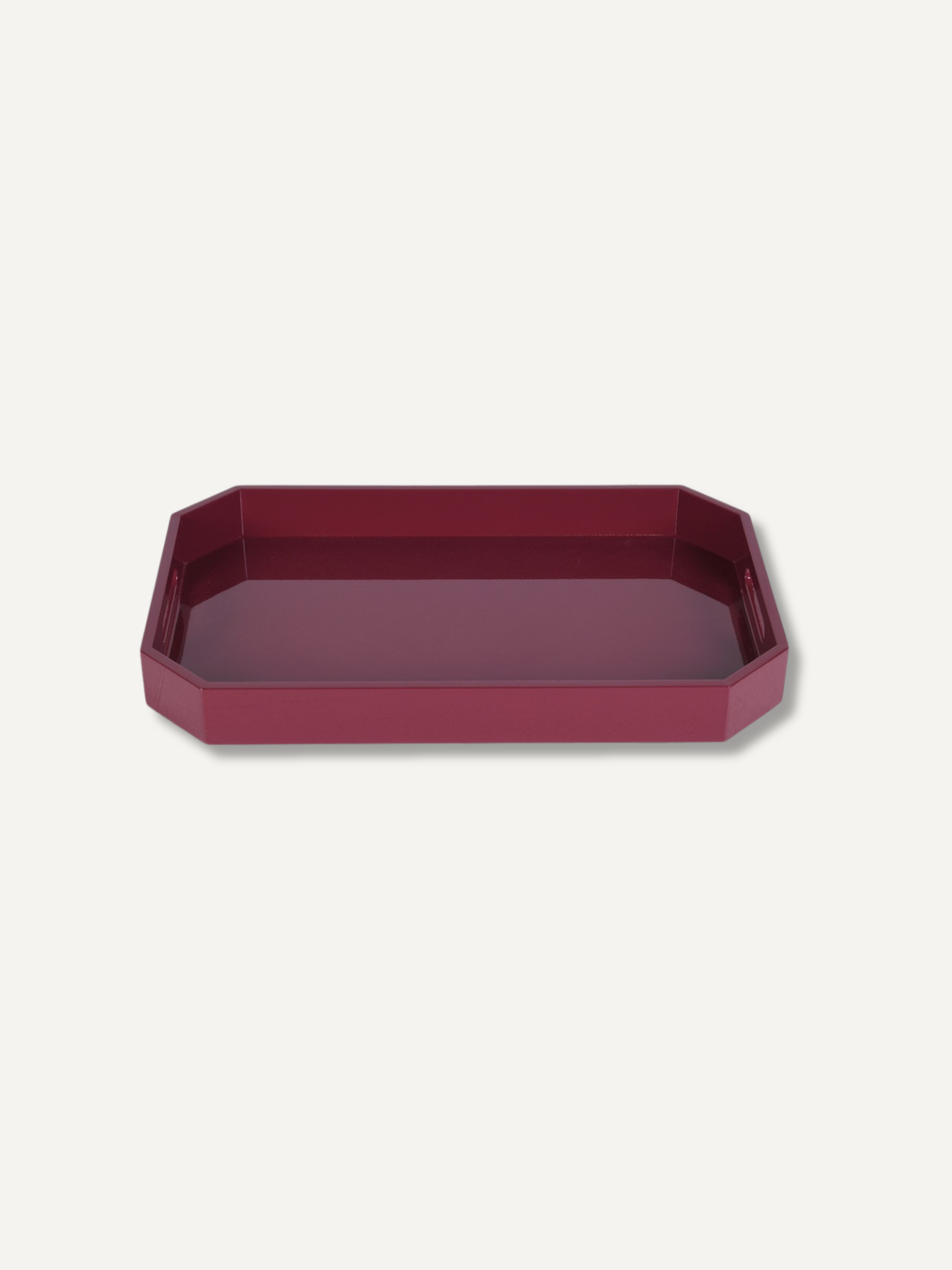 A burgundy rectangular tray with rounded corners in a deep burgundy color, shown from a top-down perspective on a light off-white background.
