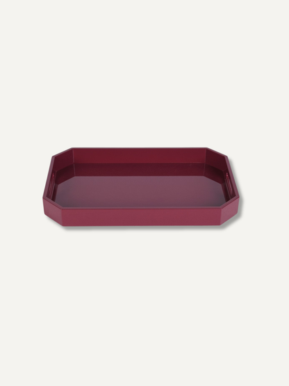 A burgundy rectangular tray with rounded corners in a deep burgundy color, shown from a top-down perspective on a light off-white background.