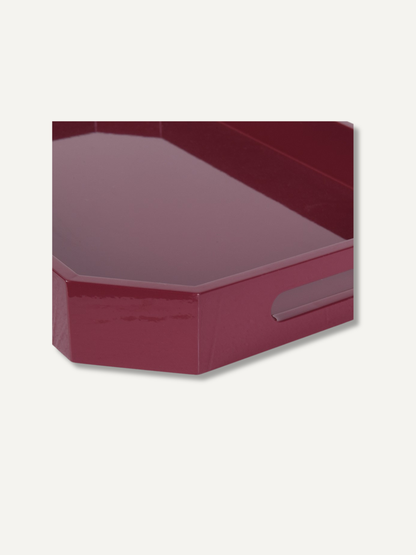 A glossy, deep burgundy hexagonal tray with a side handle cutout, shown at an angle on a light off-white background.