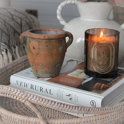 mini vintage olive pot on coffee table with rattan tray tray and lit candle 