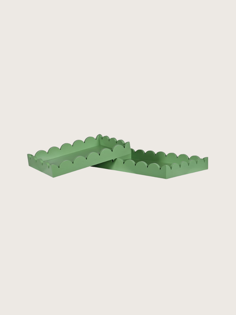 Green scalloped-edge trays on a light beige background