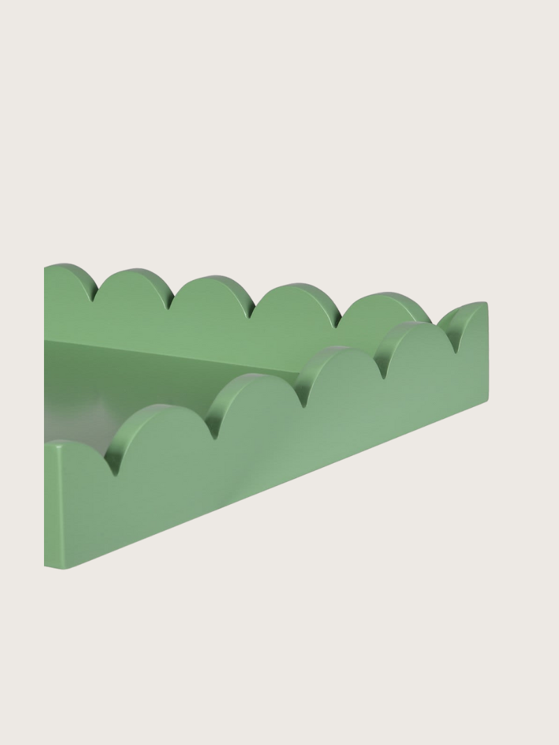 Green tray with wavy edge design on a light gray background