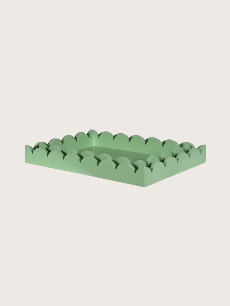Green scalloped-edge tray on a light gray background