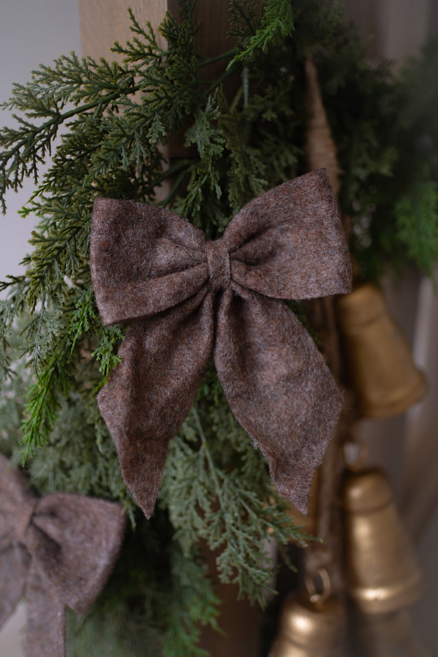 Decorative bow on a green wreath with gold accents