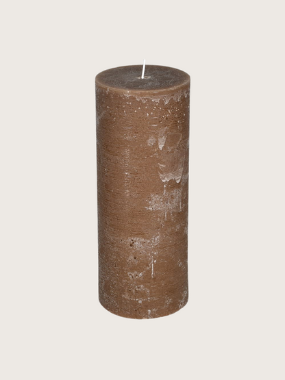 Brown textured candle on a light gray background