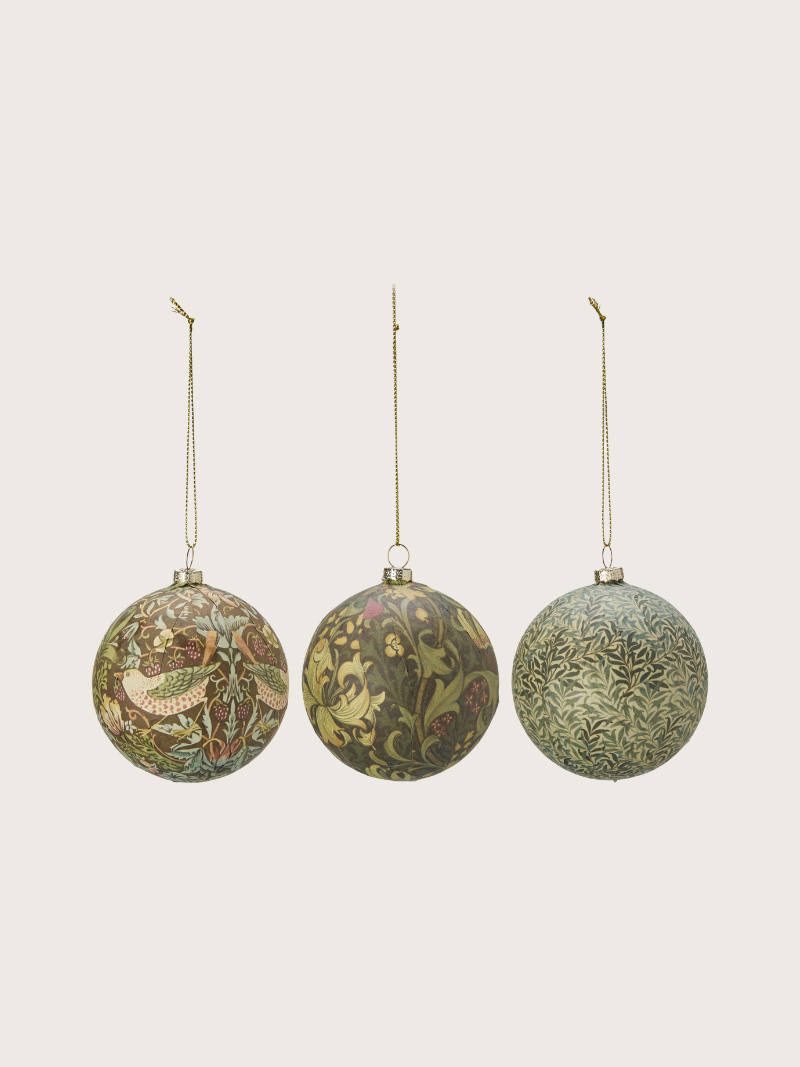 Three decorative Christmas buables with intricate patterns on a light gray background
