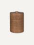 A cylindrical woven rattan storage basket with a matching lid and small top knob, shown on a plain light gray background.