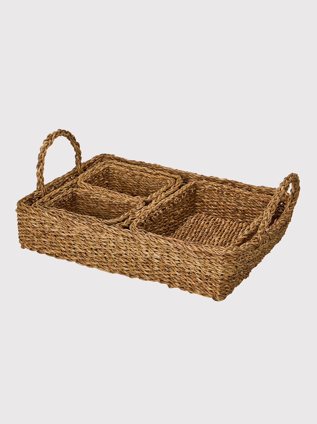 Woven seagrass tray with handles on a light gray background