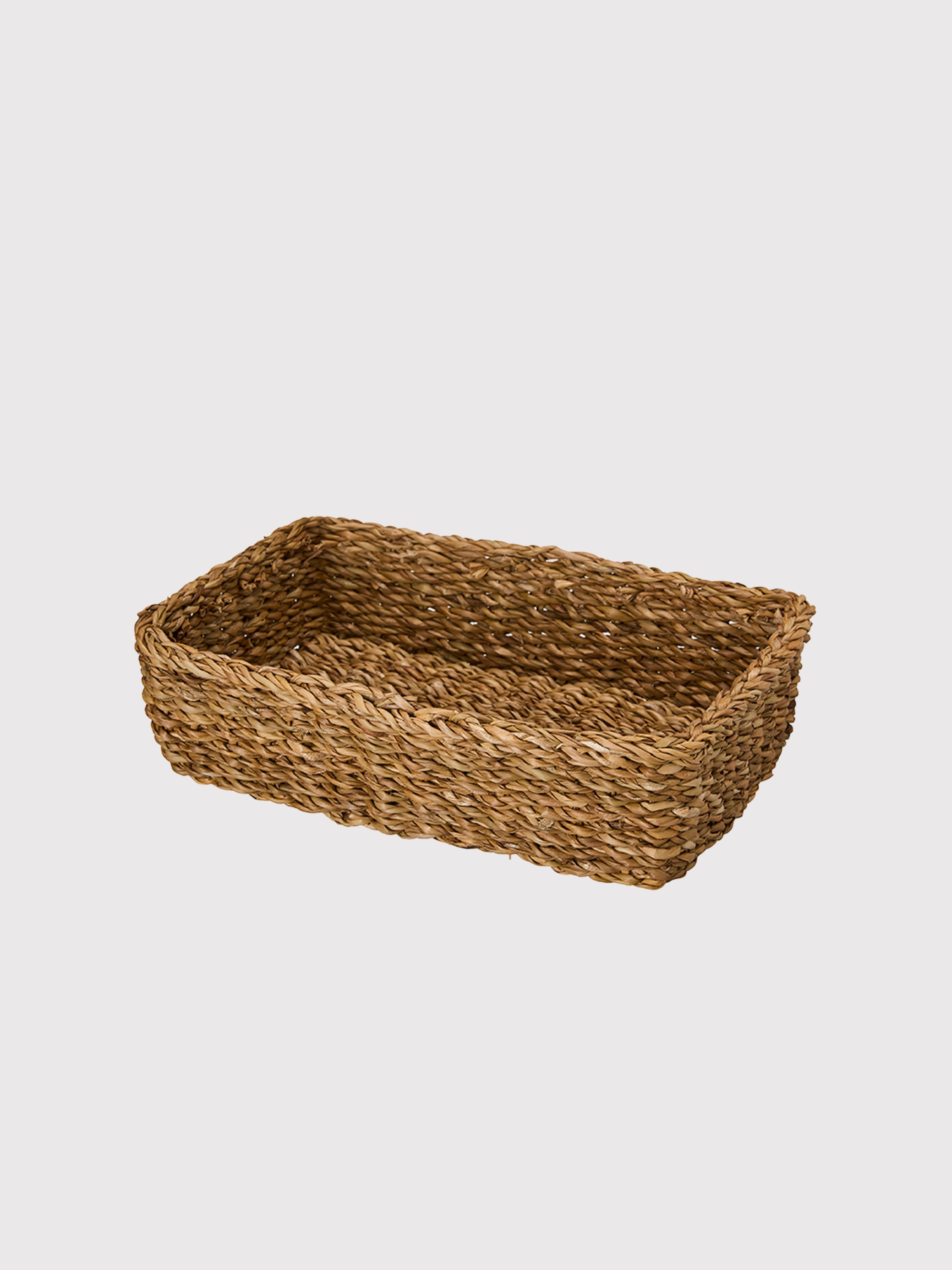 Woven brown basket on a light gray background