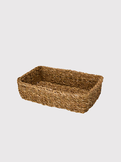 Woven brown basket on a light gray background