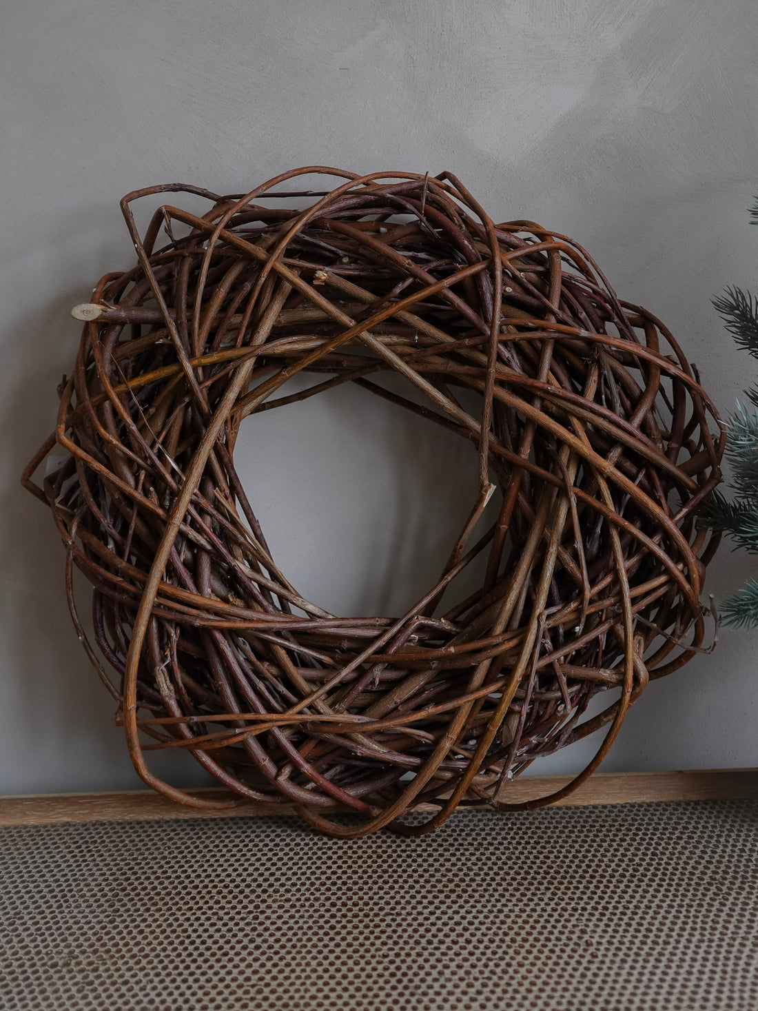 Brown twig wreath on a white surface