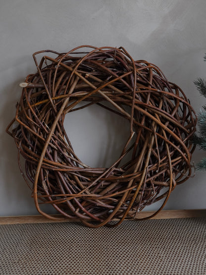 Brown twig wreath on a white surface