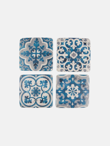 Four blue and white patterned coasters on a white background