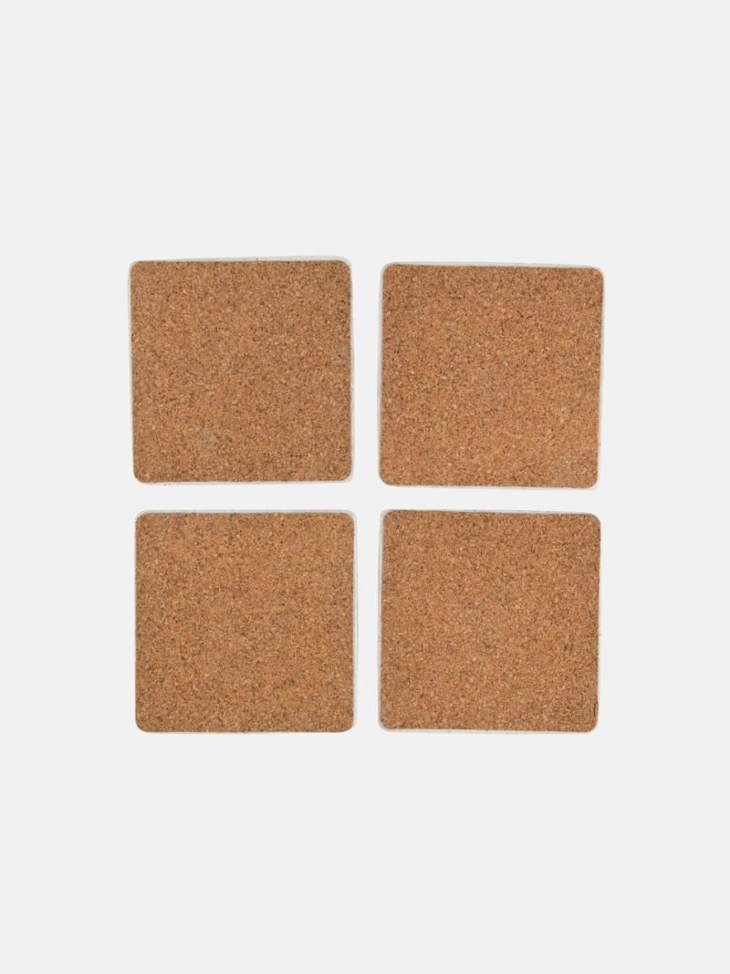 Four square cork coasters on a light gray background