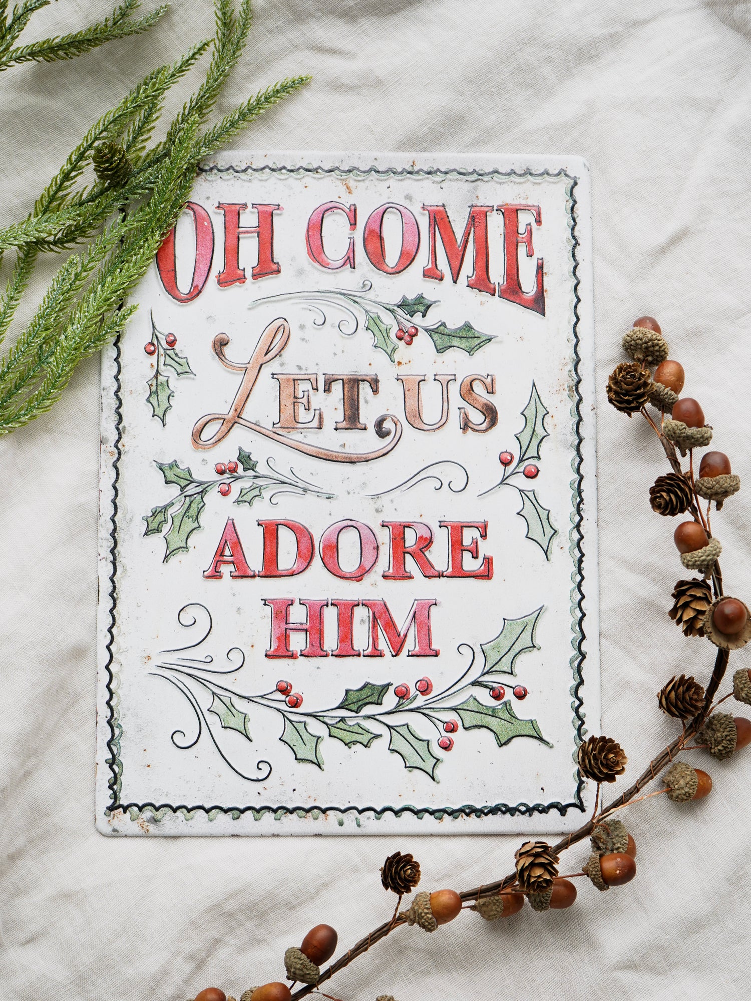 Decorative sign with Christmas text and decorations on a white background