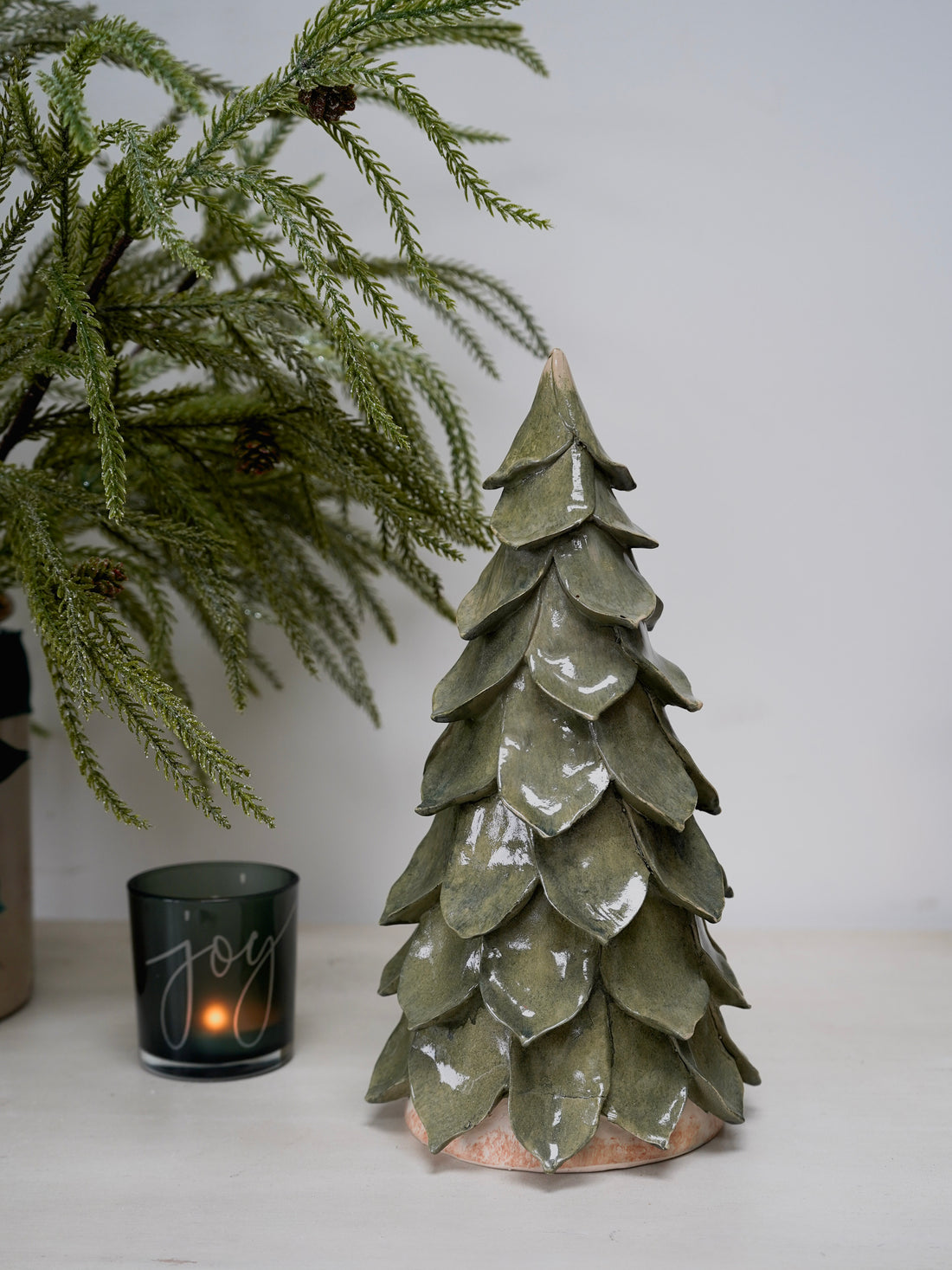 Decorative ceramic Christmas tree with a candle labeled &