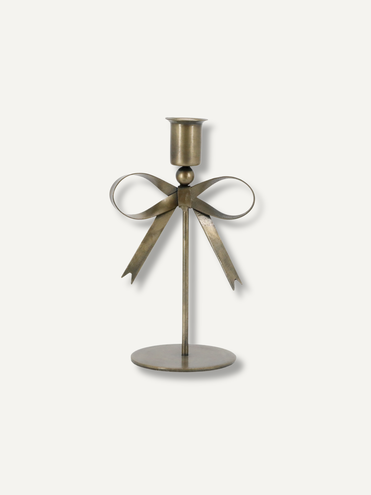 A decorative metal candle holder with a bow design, featuring a cylindrical candle cup, a central stem, and a round base, shown against a plain light background.