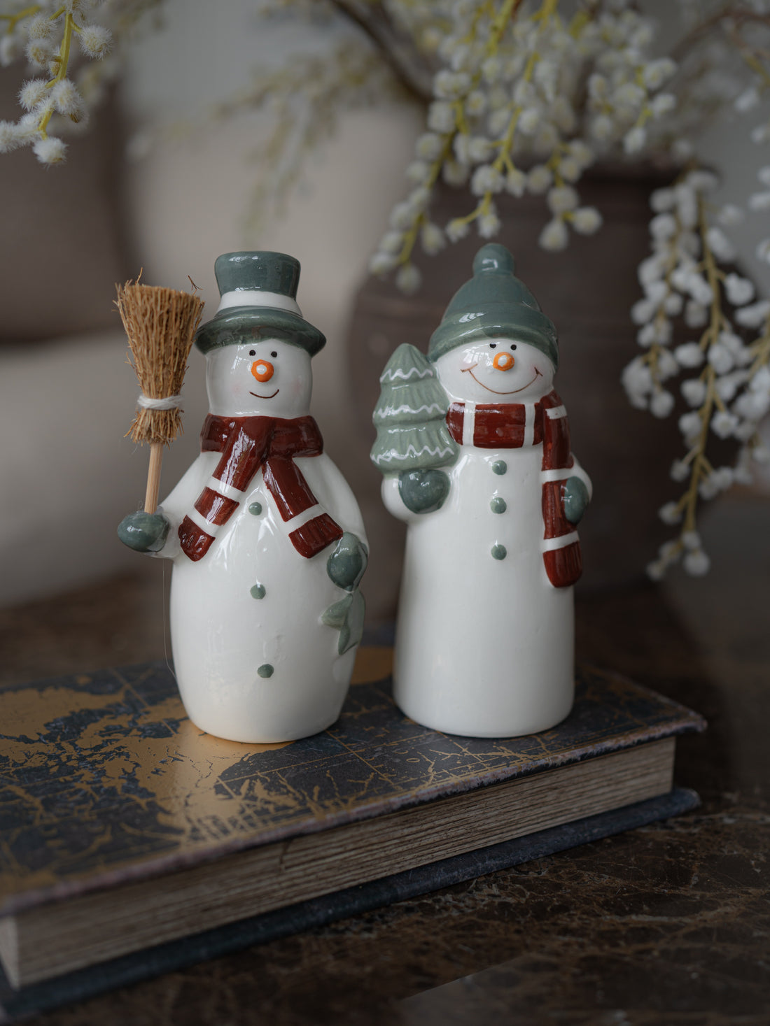 Pair of Ceramic Snowmen ornaments with Sage Scarfs on decorative storage book box
