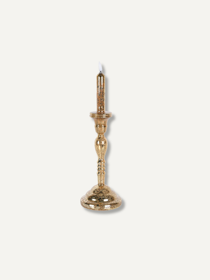 A single ornate gold led candlestick with a decorative flared base and a candle-shaped holder at the top, shown against a plain off-white background.