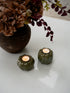Pair of Stoneware Green Pumpkin Tea Light Holders with autumn faux flower arrangement in the background