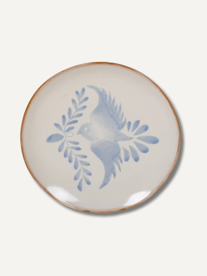 Ceramic plate with blue bird design on a white background