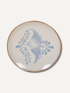 Ceramic plate with blue bird design on a white background
