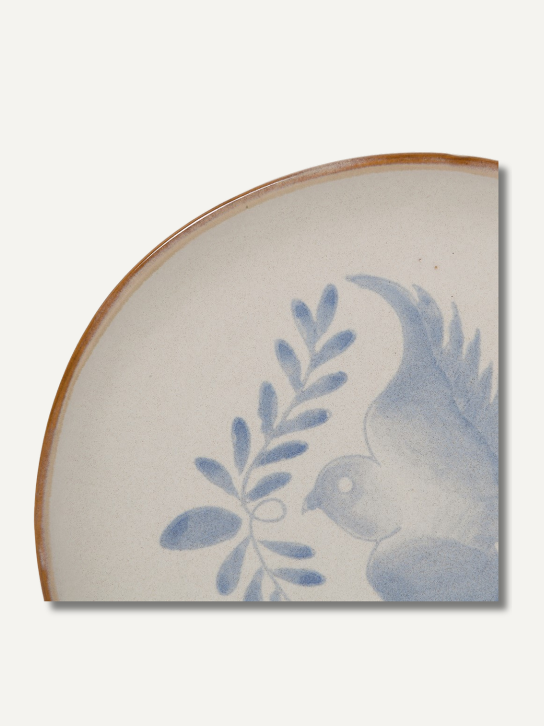 Up close of decorative ceramic plate with blue floral design on a white background