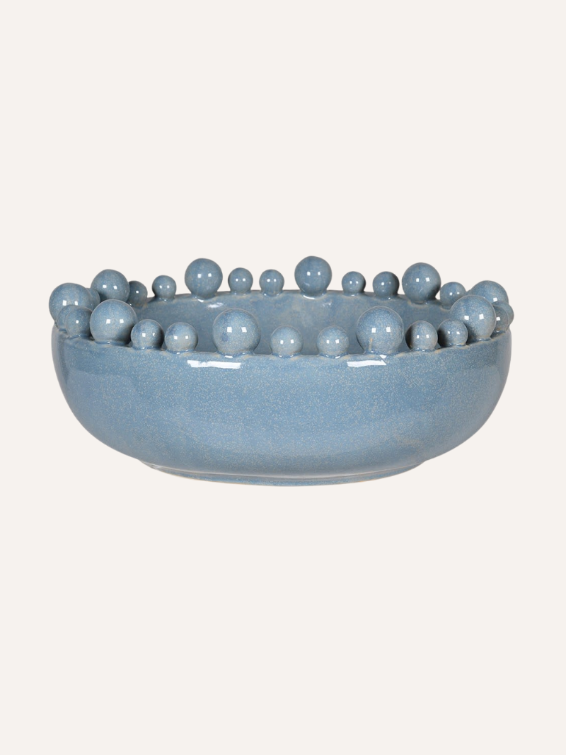Pale blue ceramic bowl with spherical bobbles  on a white background