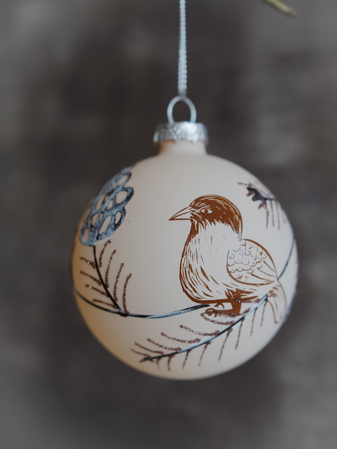 Decorative ornament with a bird design on a blurred background