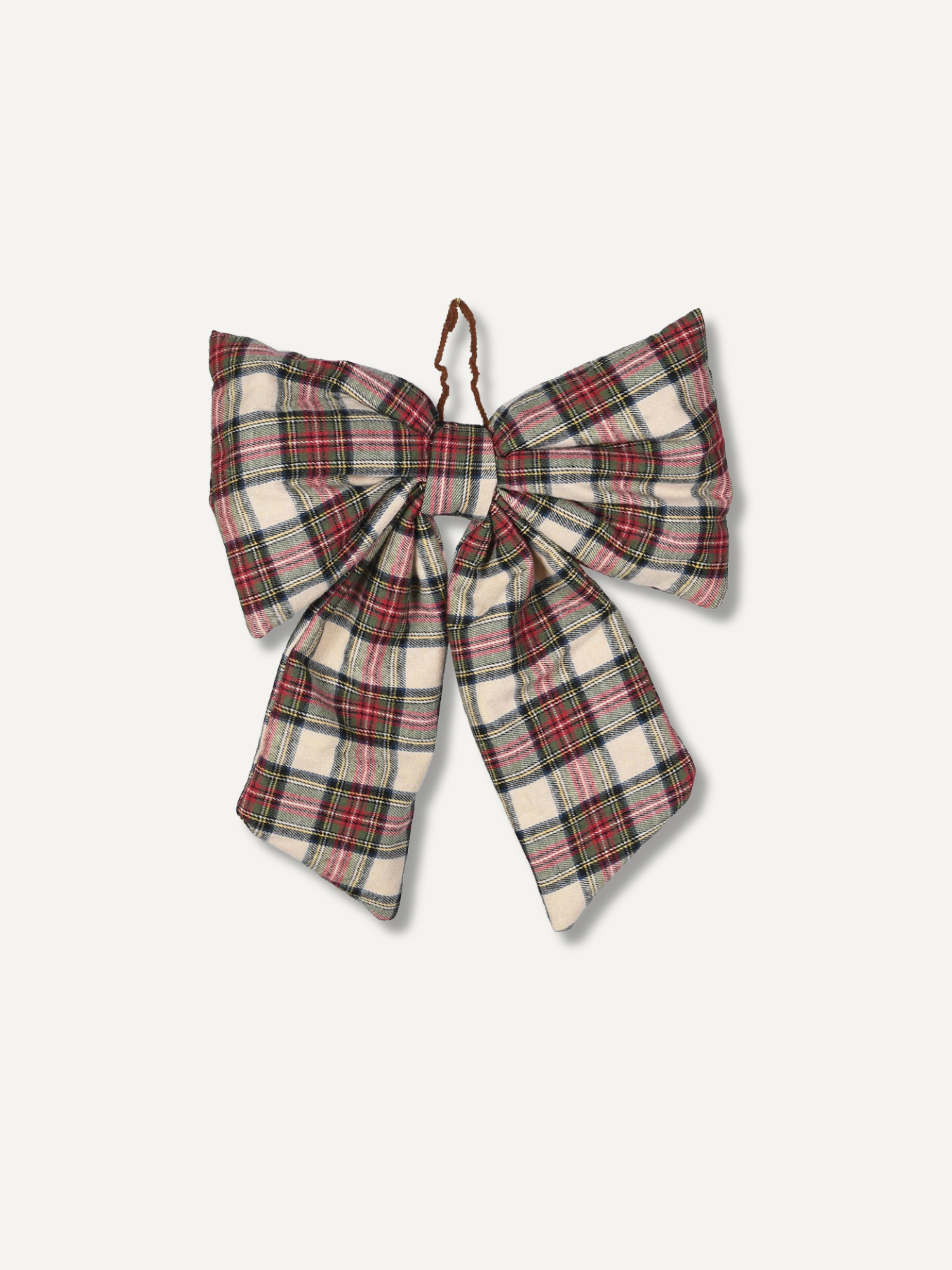 A large fabric bow in a red, green, and cream plaid pattern, featuring a small brown leather loop at the top, shown against a light off-white background.