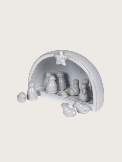 Ceramic nativity set with star on a white background