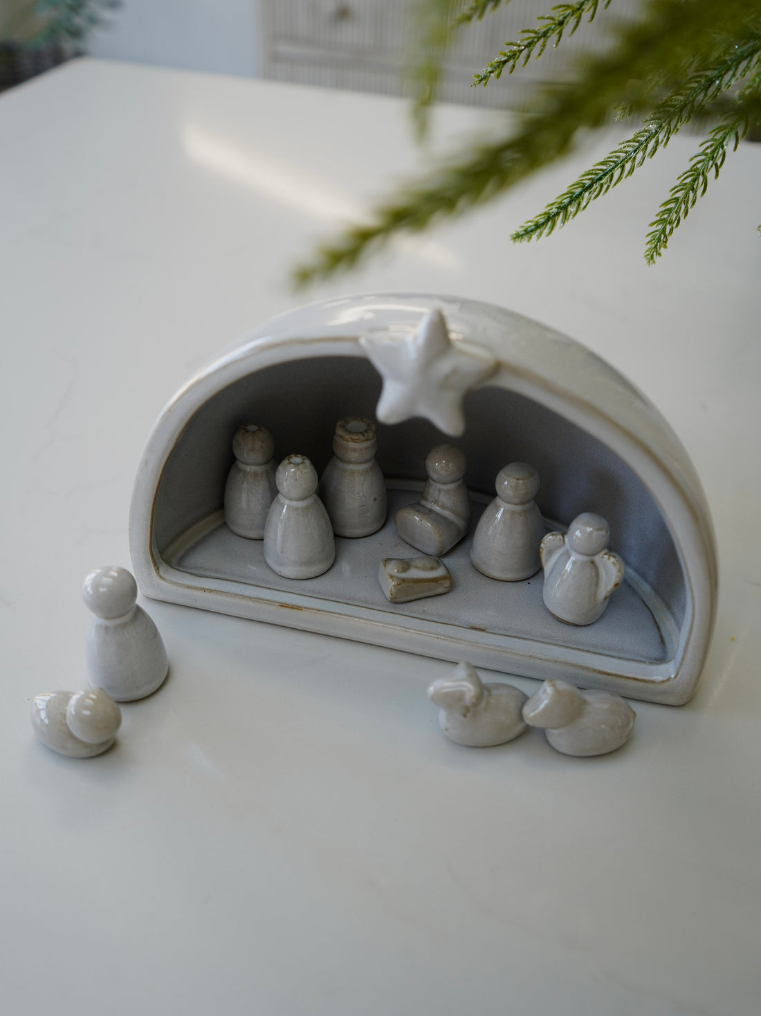 Ceramic nativity scene with figures on a white surface