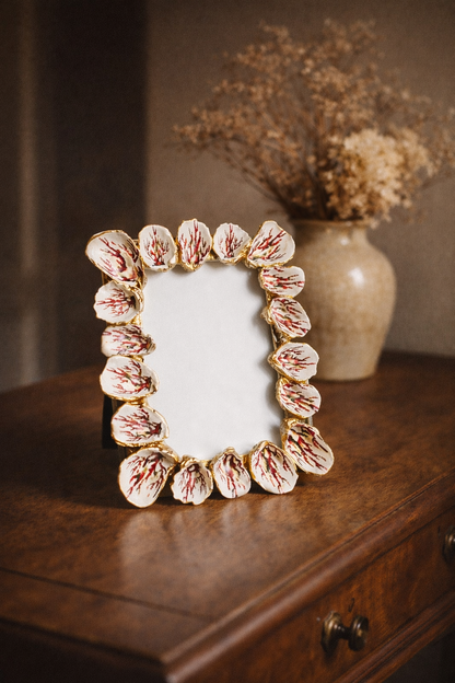 Decorative photo frame with floral design on a wooden surface