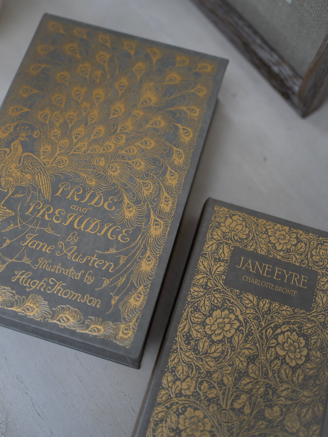 Two books with ornate covers featuring &