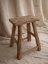 Wooden stool on a beige fabric background for home decor
