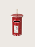 Red postbox-shaped ornament with a white label on a beige background