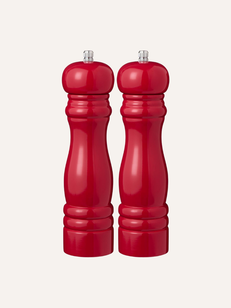 Two red pepper mills on a white background
