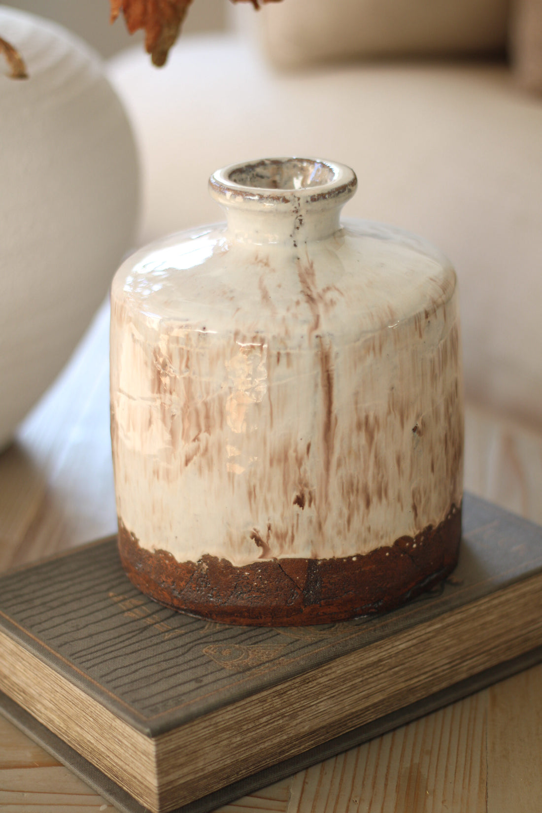 Terracotta vase with a rustic finish on a wooden surface