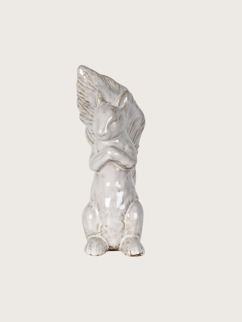 White ceramic squirrel on a light gray background