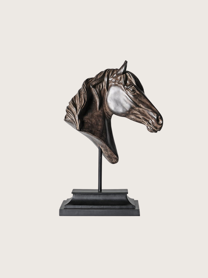 Bronze horse head sculpture on a stand against a white background