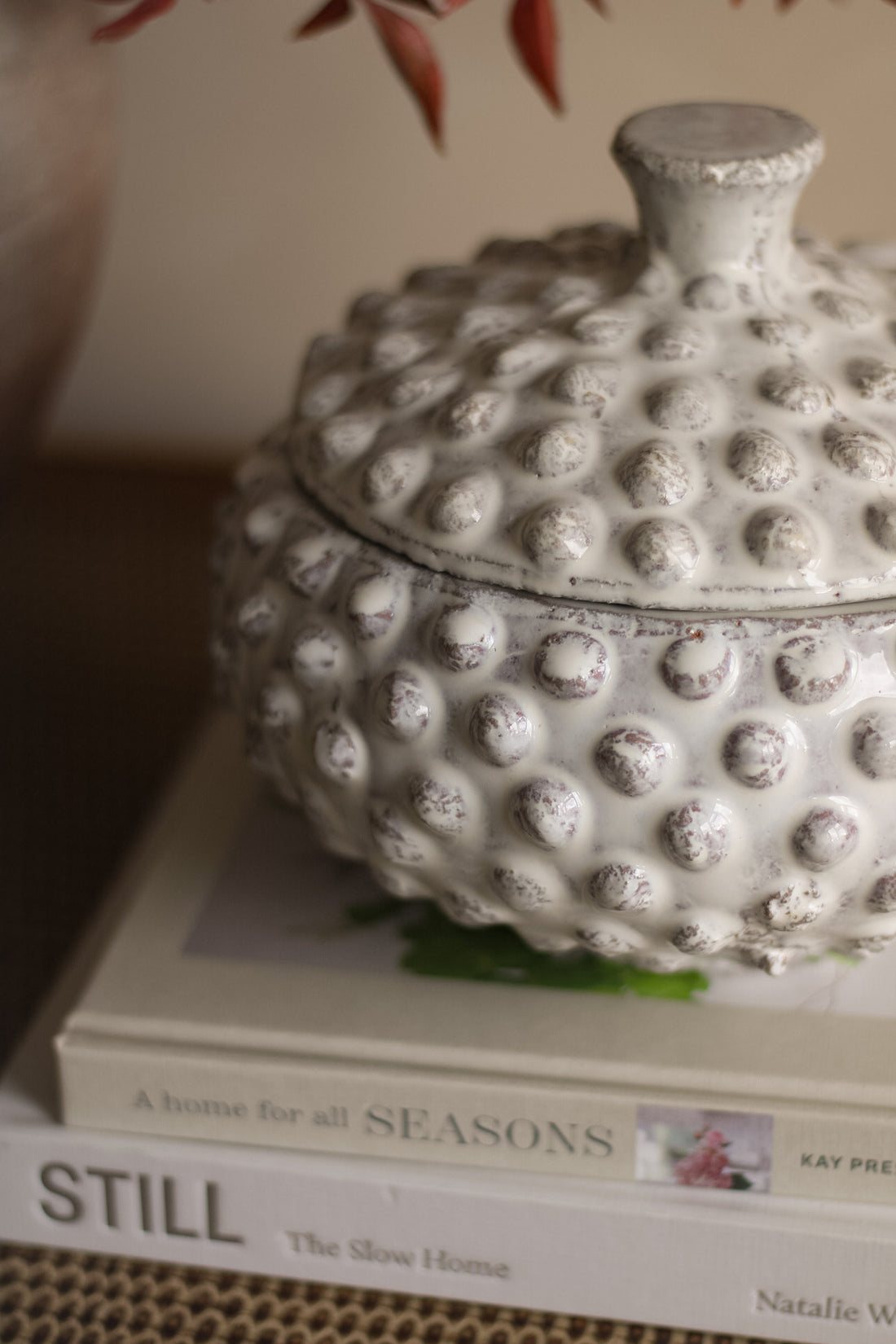 Decorative white textured box on top of a book with a blurred background