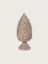 Decorative pine cone-shaped finial object on a light gray background