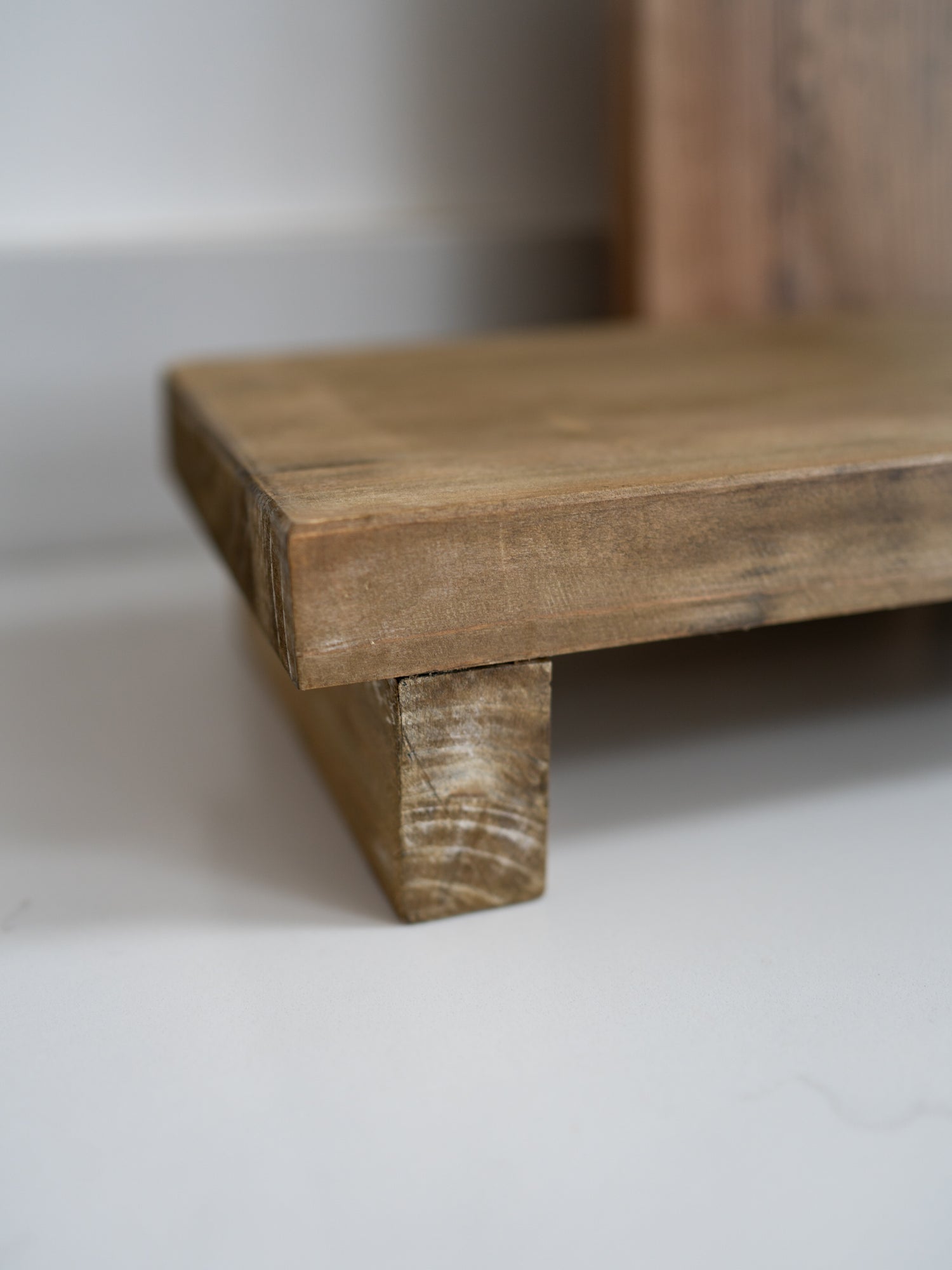 Close-up of a wooden shelf with a white background