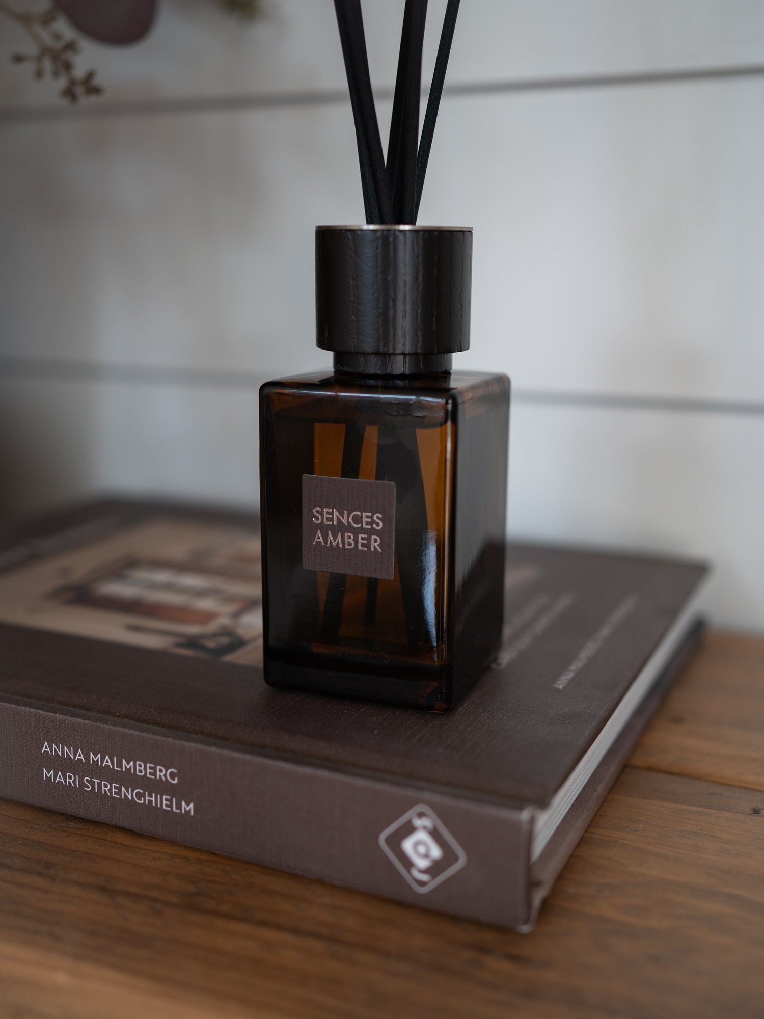 A reed diffuser bottle labeled &